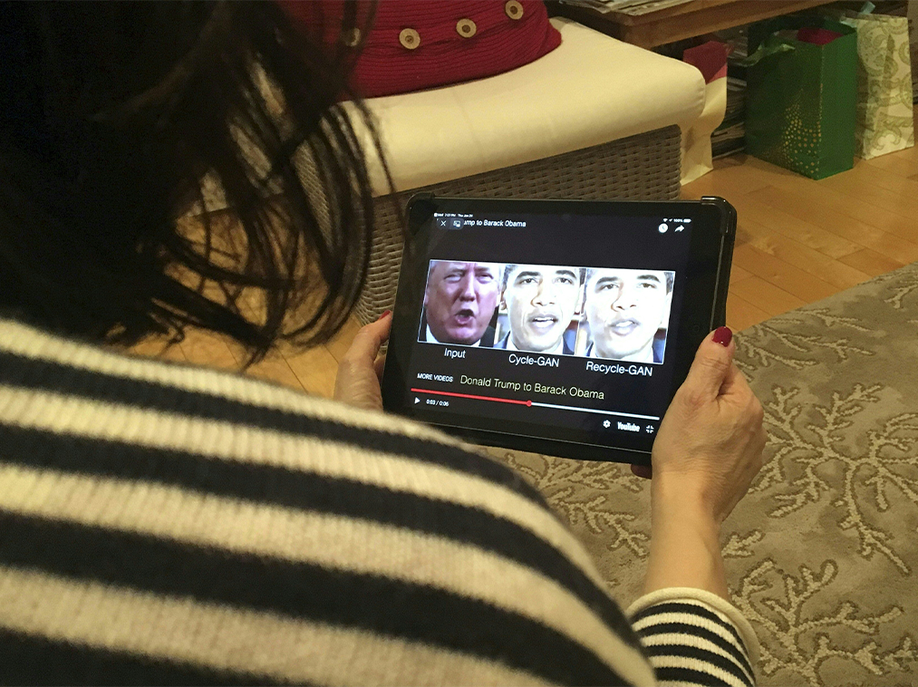 A woman in Washington, DC, views a manipulated video on January 24, 2019, that changes what is said by President Donald Trump and former president Barack Obama, illustrating how deepfake technology can deceive viewers. - "Deepfake" videos that manipulate reality are becoming more sophisticated and realistic as a result of advances in artificial intelligence, creating a potential for new kinds of misinformation with devastating consequences.