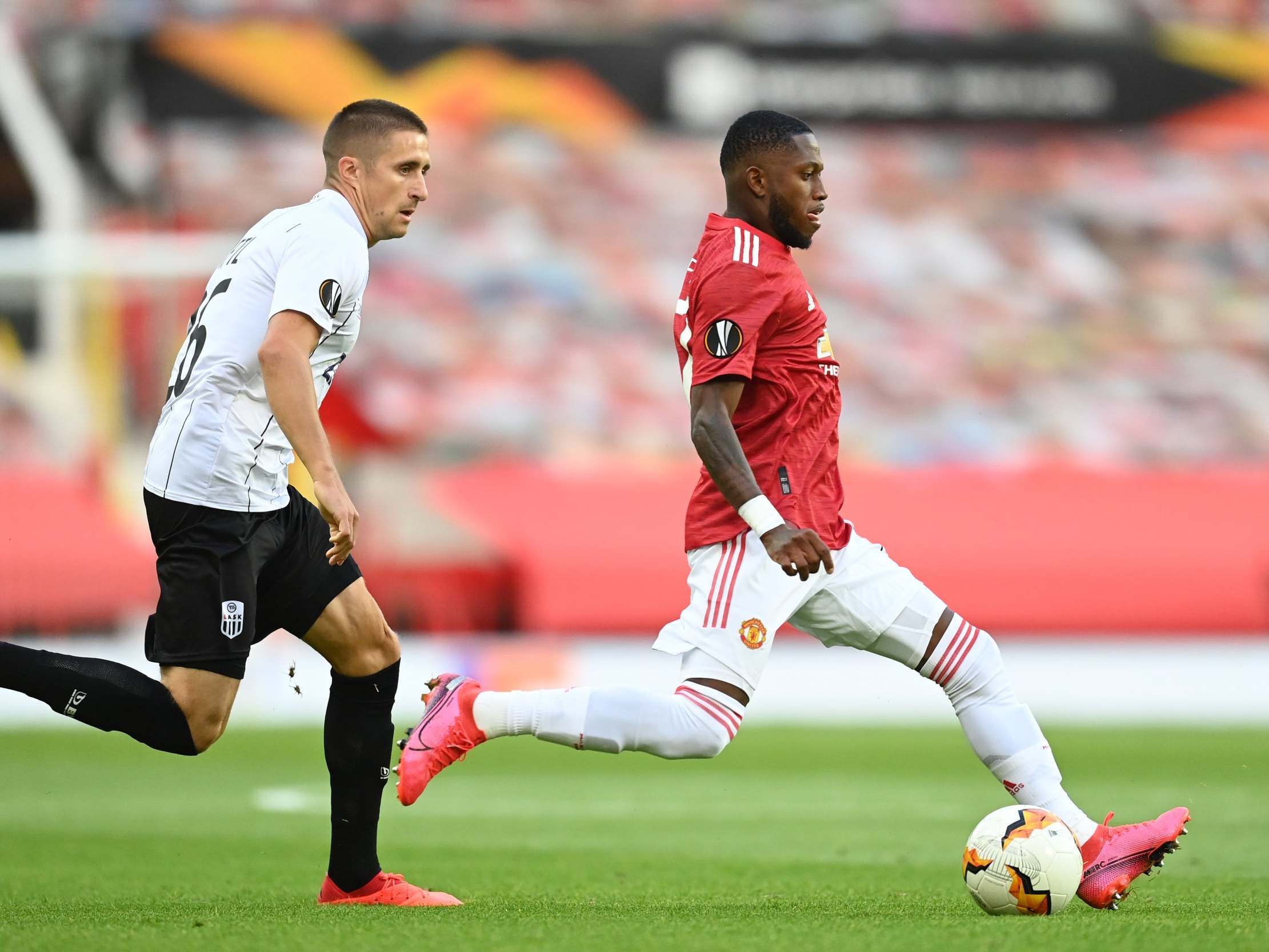 Fred looks to play a pass in midfield