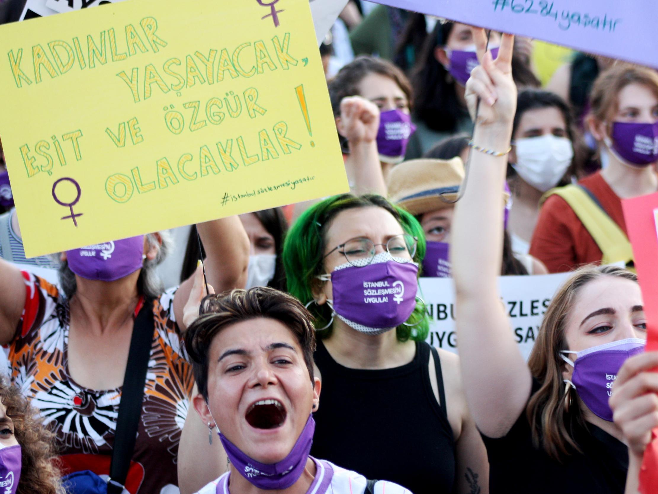Protester holds a sign reading ‘Women will live freely and equally’ at an Istanbul protest against femicide in Turkey