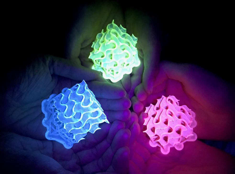 Glowing 3D-printed gyroids made with bright SMILES materials.