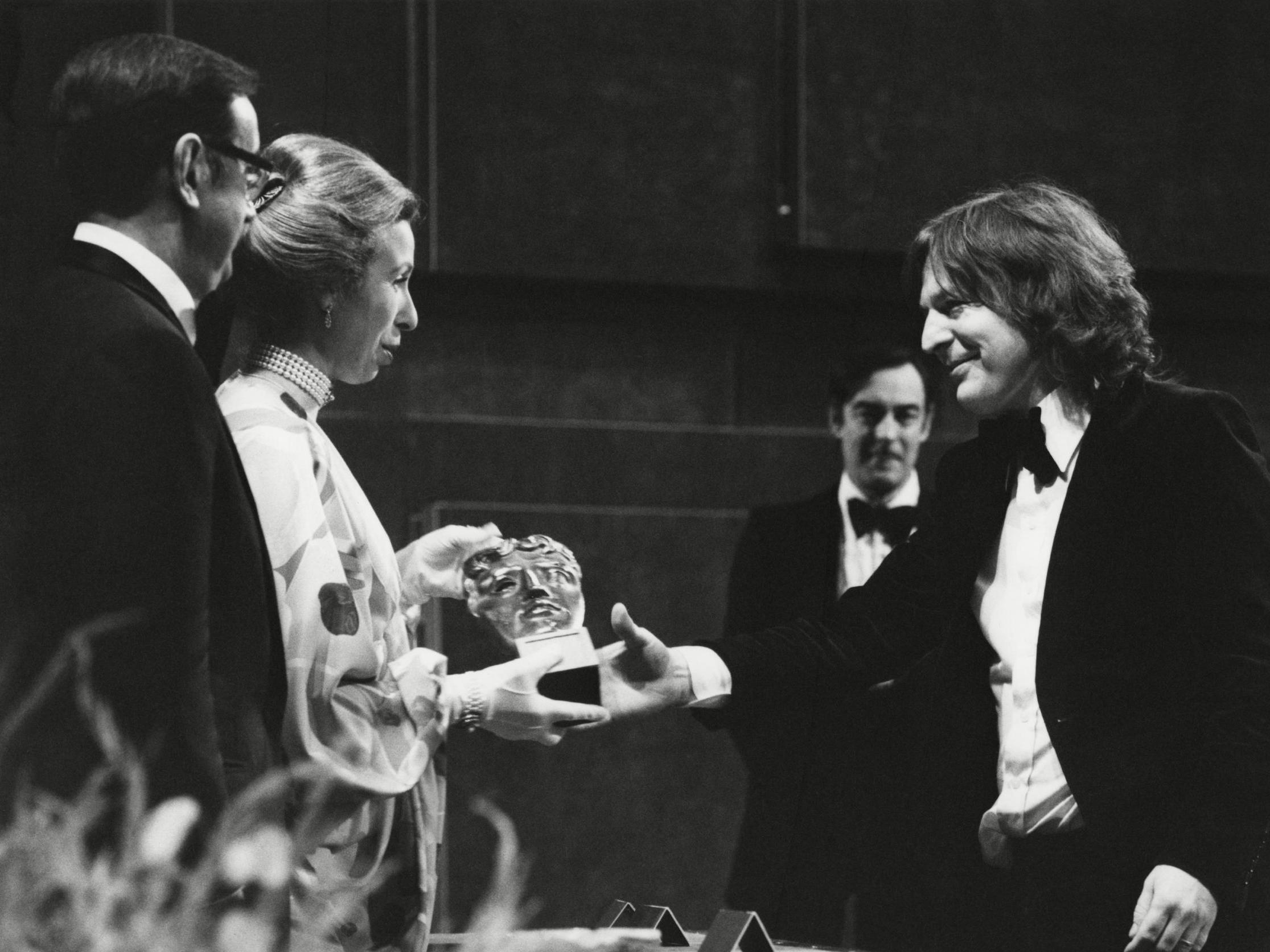 Parker (right) collects his Bafta in 1977
