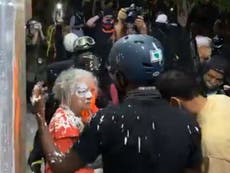 Woman covered in paint during renewed Portland protests