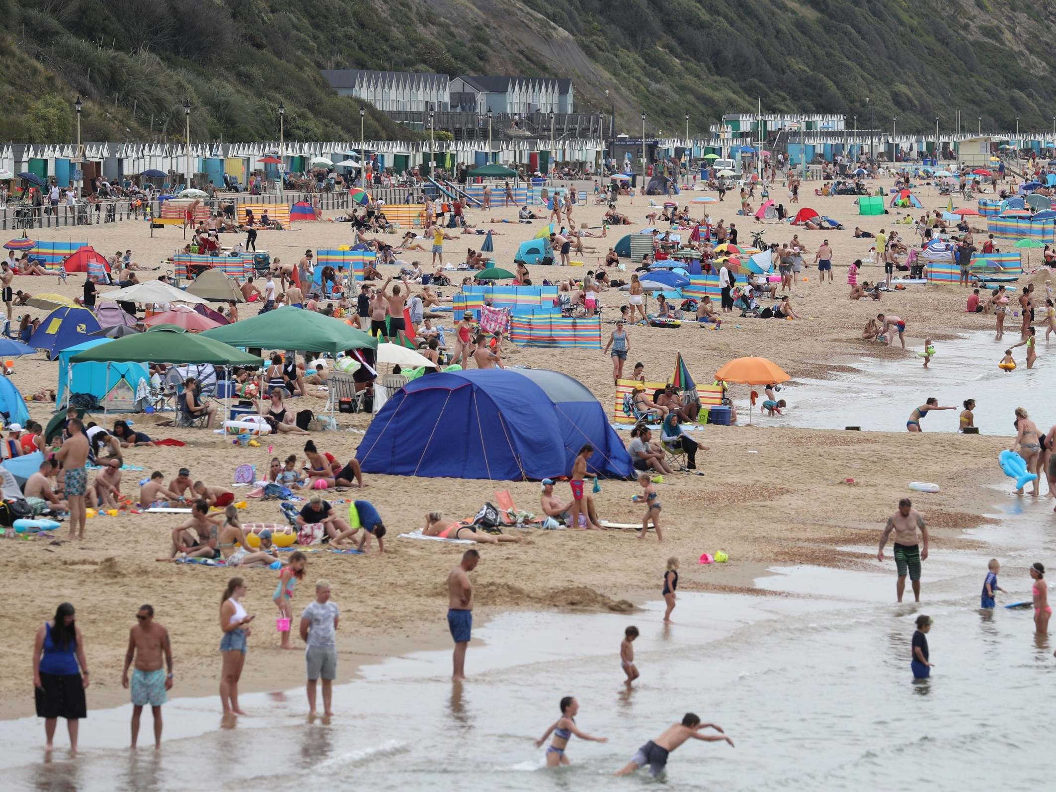 People enjoy the hot weather at Boscombe beach in Dorset