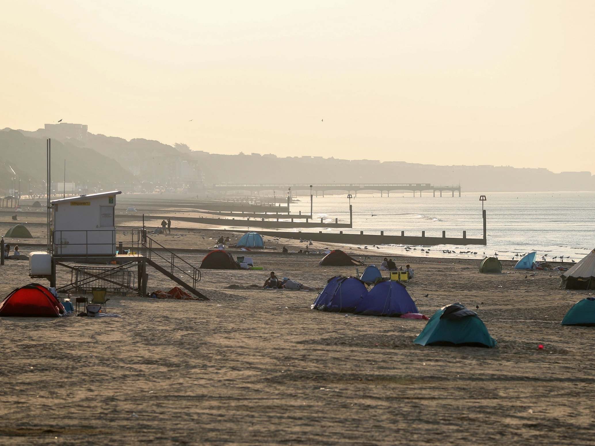 Tents pitched up on Bournemouth beach in Dorset as the sun rises