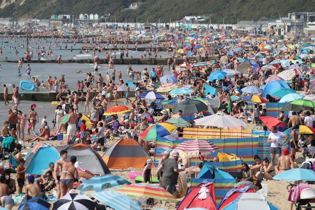 Throngs of people crowd Bournemouth beach in Dorset for third day in a row as heatwave continues