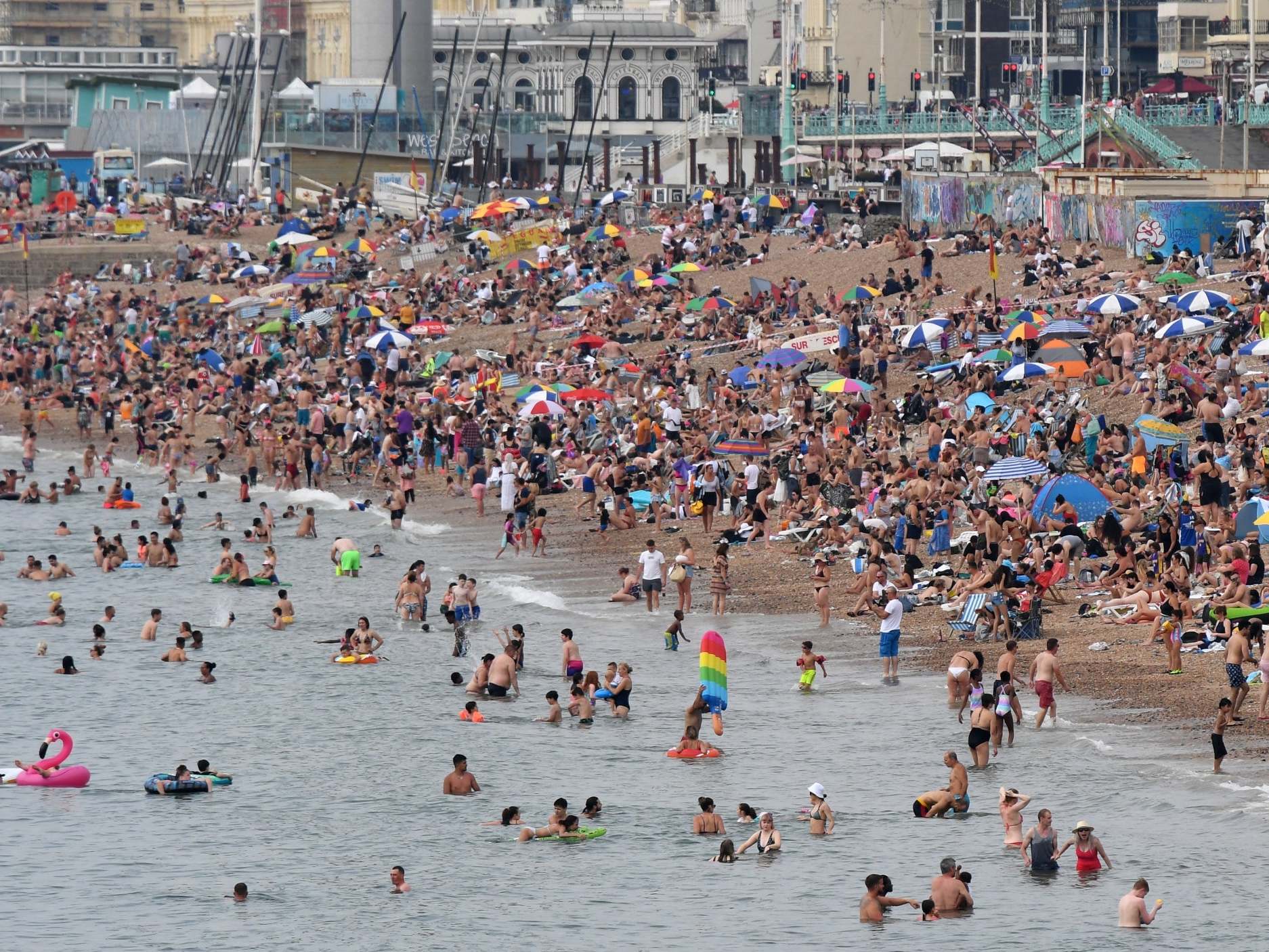 Brighton beach is packed as the south of England basks in a summer heatwave (Images)