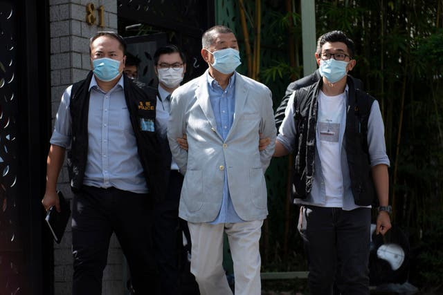 <p>A file image of Hong Kong media tycoon Jimmy Lai being taken away after his arrest in August 2020</p>