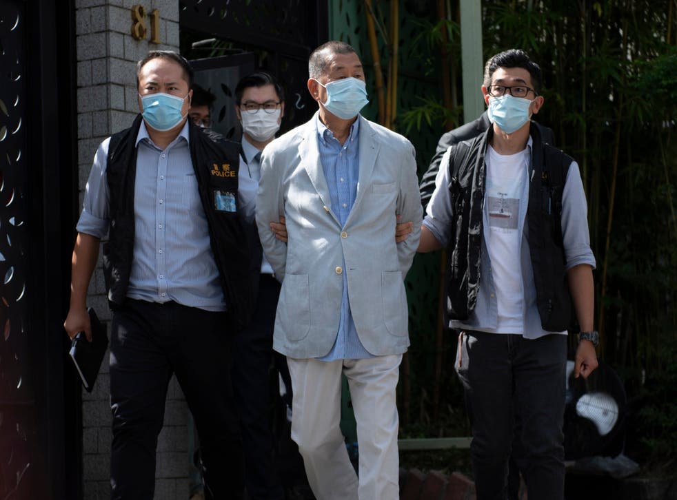 Jimmy Lai (centre), the pro-democracy founder of a Hong Kong newspaper, being arrested under the national security law