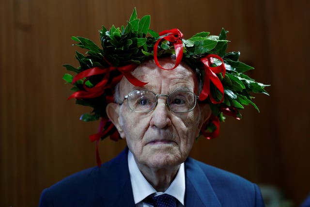 Giuseppe Paterno, 96, wears a traditional laurel wreath awarded to Italian students when they graduate