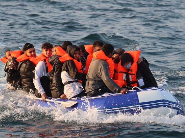 A group of migrants crossing the Channel in a small boat headed in the direction of Dover, Kent, on 10 August