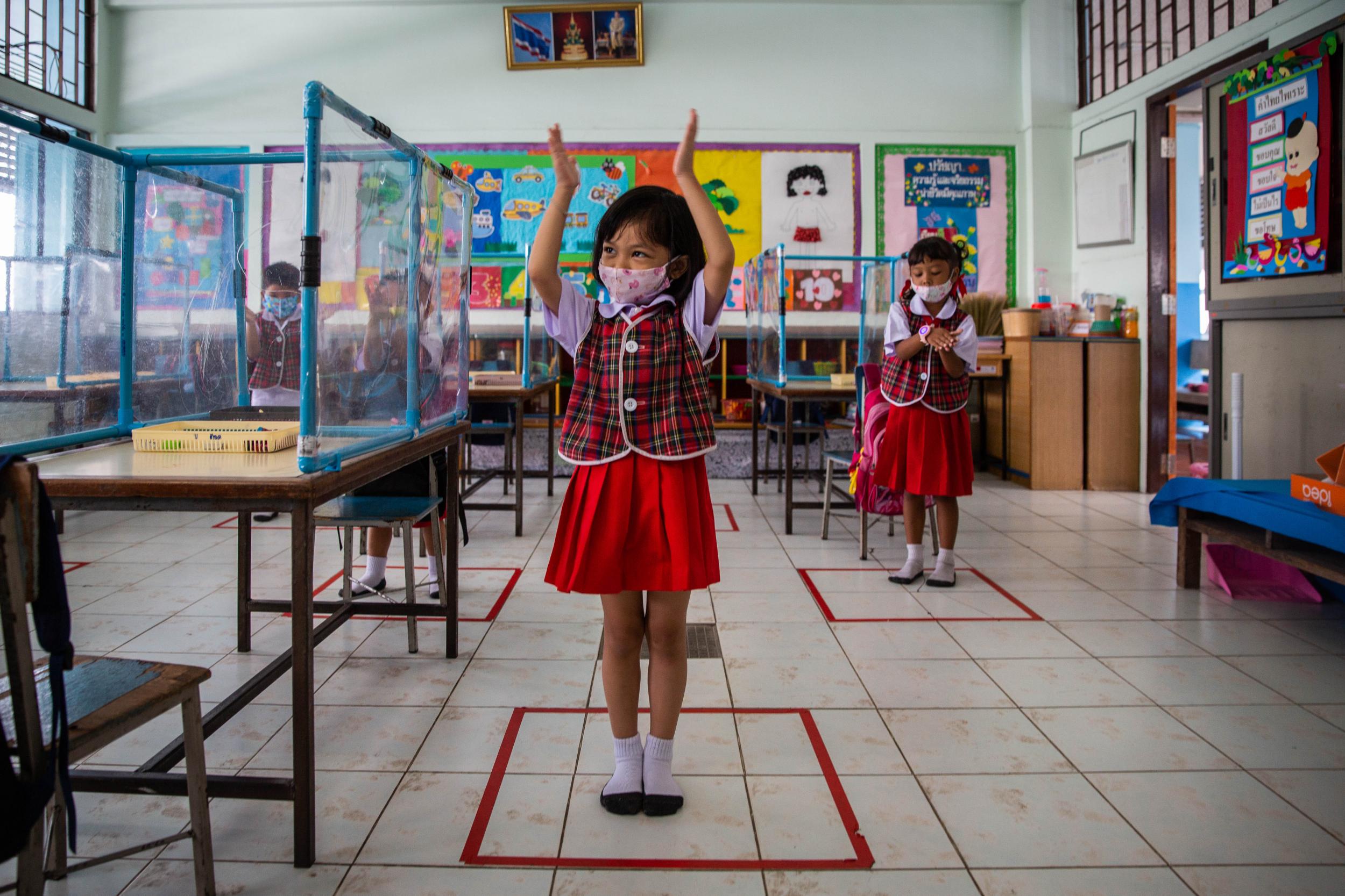 Pupils stand in socially distanced boxes that are marked out in a classroom at Wat Khlong Toey School in Bangkok, Thailand, on August 10, 2020. (Lauren DeCicca/Getty Images )