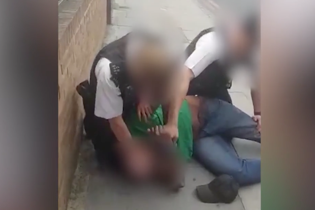 An officer who appeared to press his knee into the neck of 48-year-old Marcus Coutain is under criminal investigation