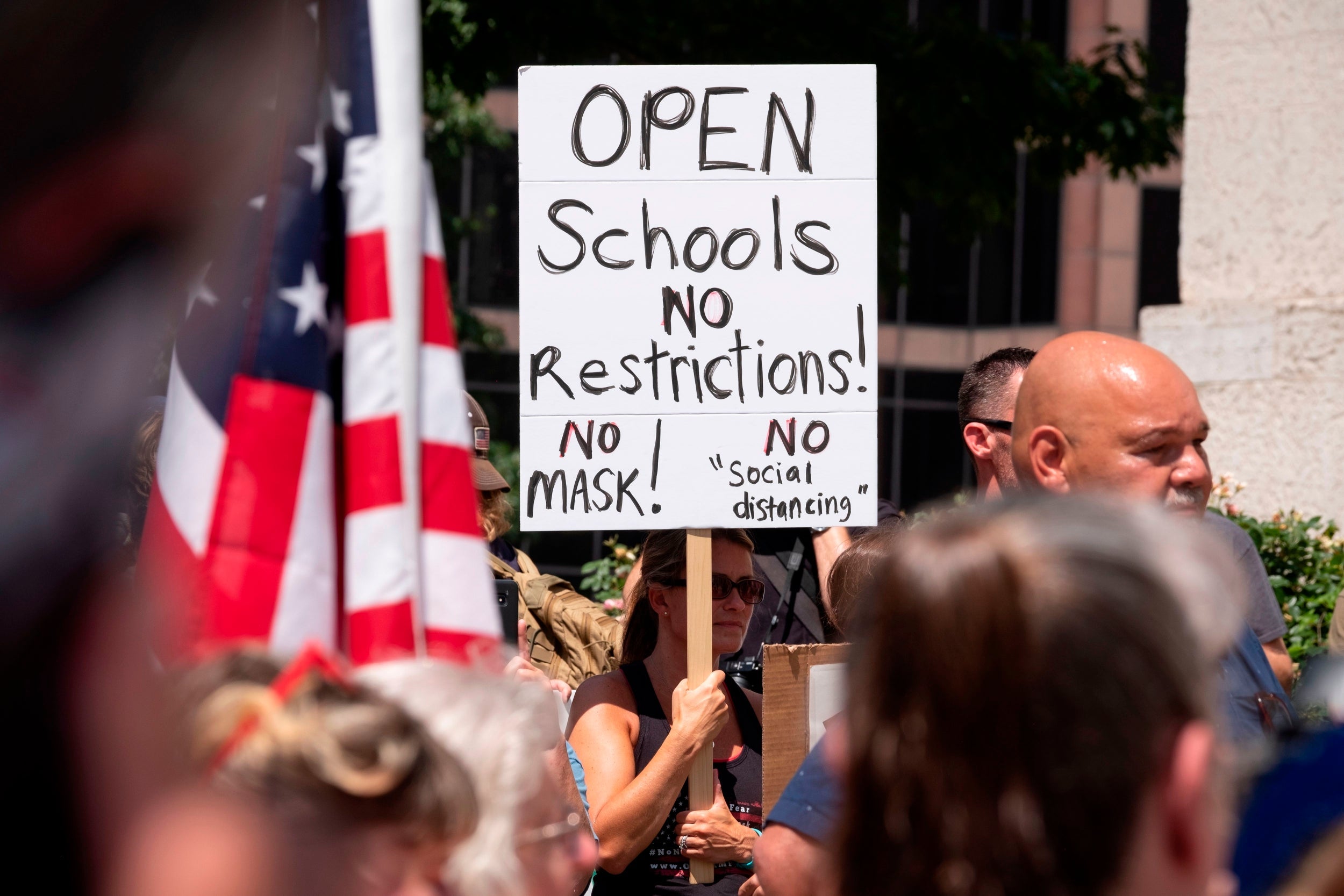 An anti-mask protestor holds up a sign in Columbus, Ohio, on 18 July