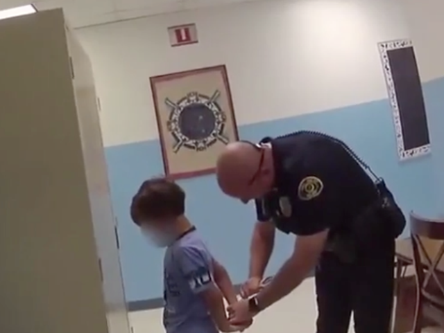 A video has shown police try to handcuff a boy, whose lawyers say has special needs