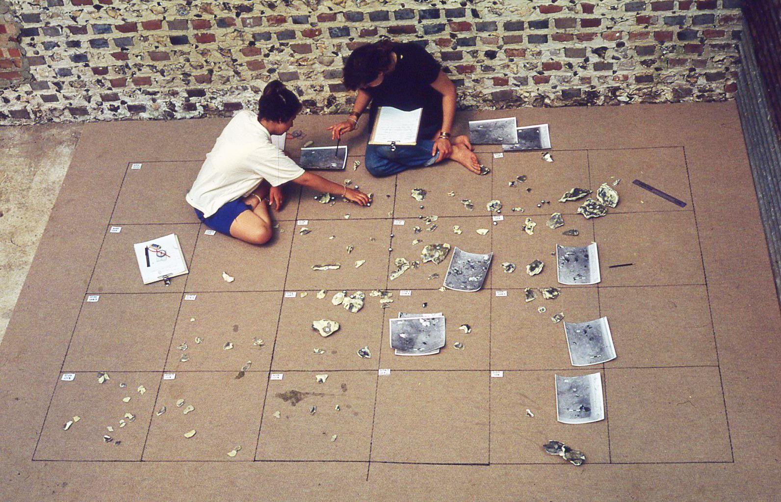 Beginning to refit the flint shards in 1990. Once cleaned and marked with a unique number the flint shards were laid out as found in the site and pieced back together. (Copyright UCL Institute of Archaeology)