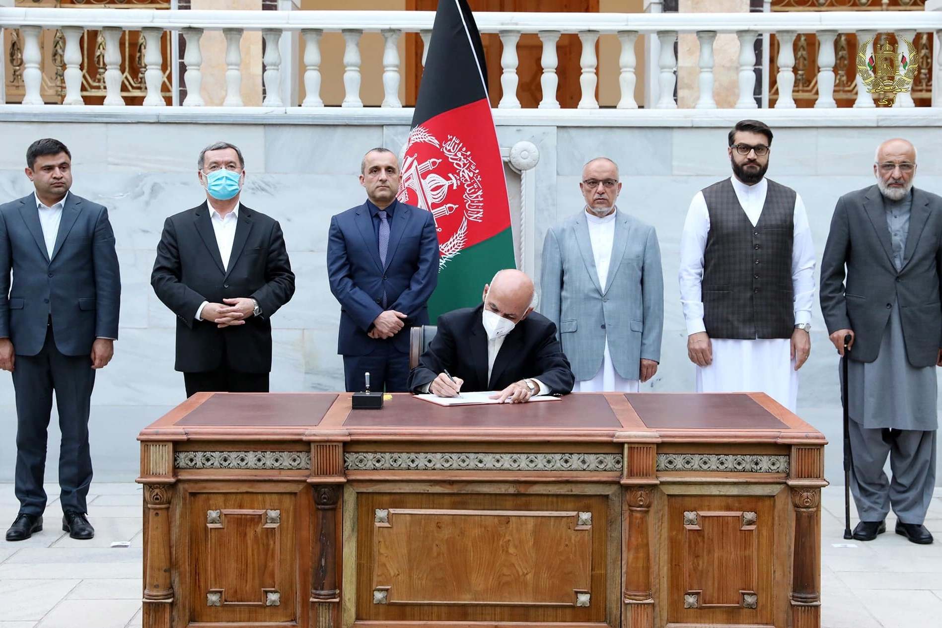 President Ashraf Ghani signs the decree in Kabul on Monday