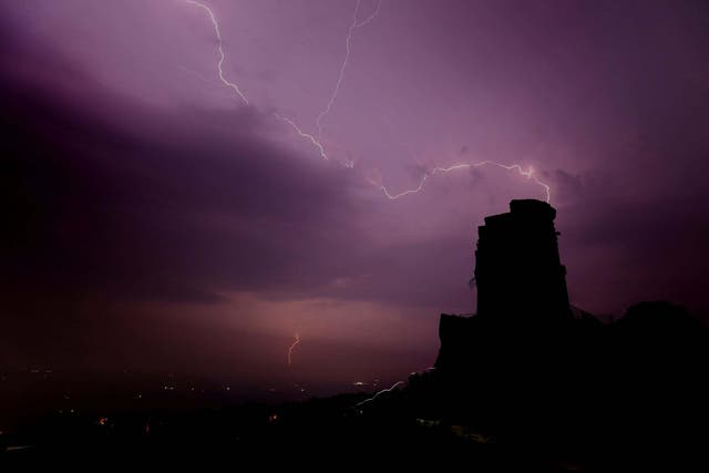 Lightning is seen over Mow Cop, Staffordshire