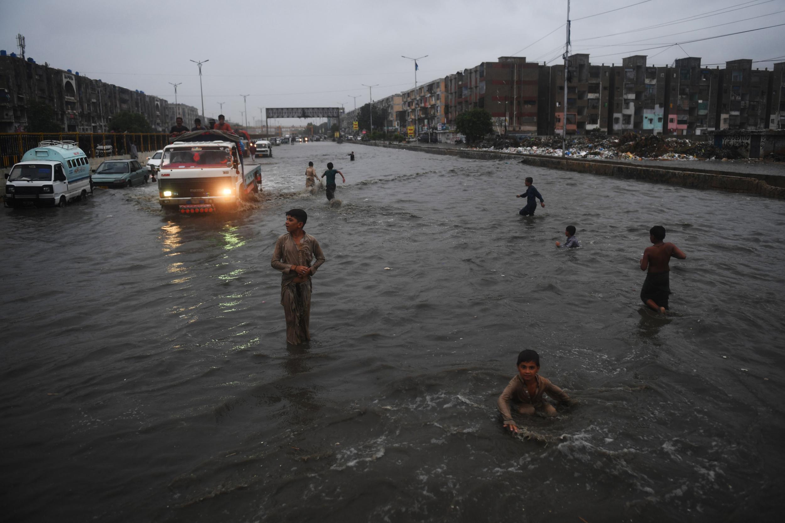 Children play in one of the city’s many flooded streets