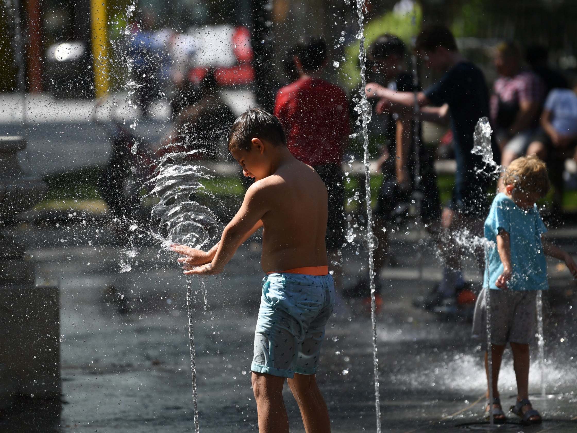 Children cool themselves off in fountains in Leicester Square during a heatwave in London