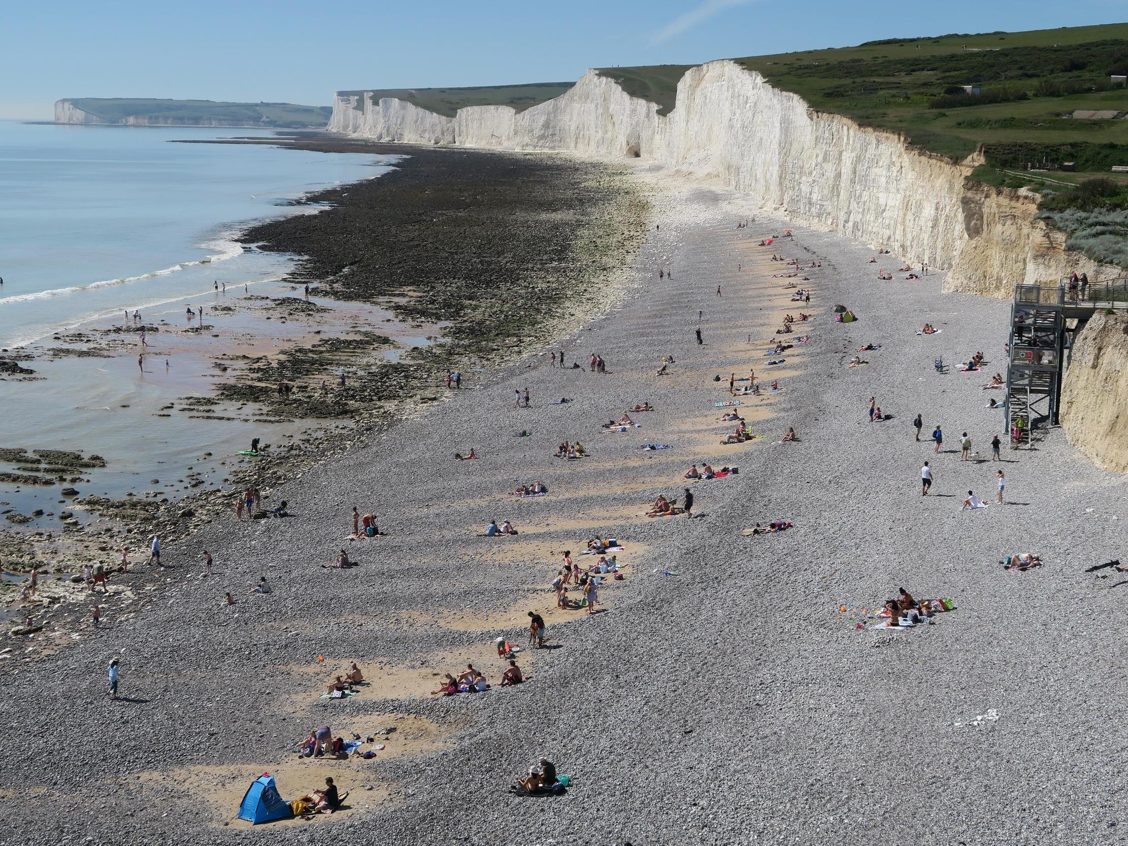 People enjoy the good weather on a beach near Eastbourne, Sussex, on 20 May, 2020.