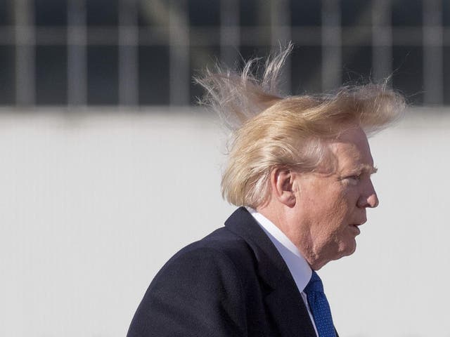US president Donald Trump's blows in the wind as he boards Air Force One before flying to Vietnam to attend the annual Asia Pacific Economic Cooperation (APEC) summit at Beijing airport on 10 November 2017