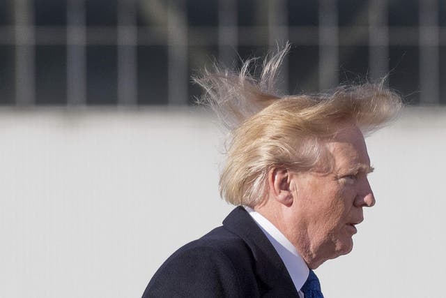 US president Donald Trump's blows in the wind as he boards Air Force One before flying to Vietnam to attend the annual Asia Pacific Economic Cooperation (APEC) summit at Beijing airport on 10 November 2017