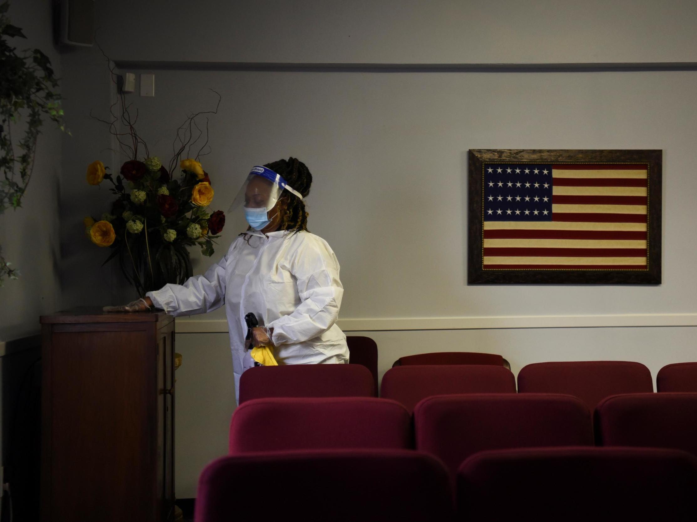 Shayla Williams, 39, disinfects surfaces to prevent the spread of the coronavirus at Beresford Funeral Service in Houston, Texas. The US has seen more than 166,000 deaths during the pandemic, ranking it first for total fatalities.