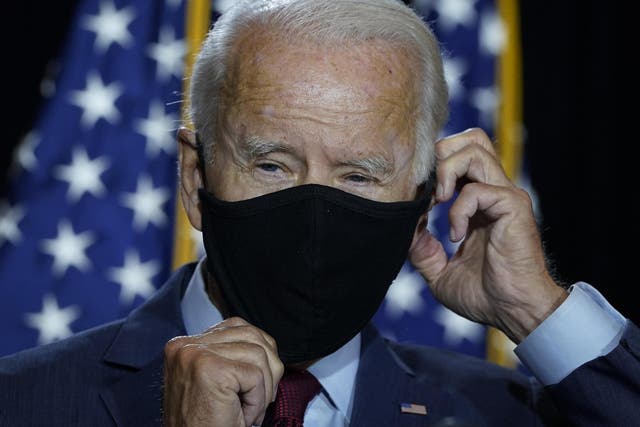 Presumptive Democratic presidential nominee former vice president Joe Biden puts his mask back on after delivering remarks following a coronavirus briefing with health experts at the Hotel DuPont on 13 August 2020 in Wilmington, Delaware