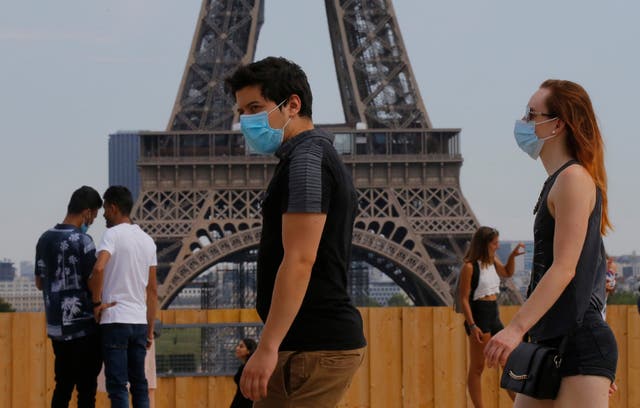 People wearing masks to prevent the spread of COVID-19 walk at Trocadero plaza near Eiffel Tower in Paris