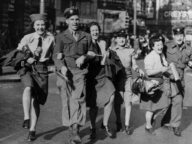 WAAFs link arms with soldiers during the VJ Day celebrations in Piccadilly Circus, 10 August 1945