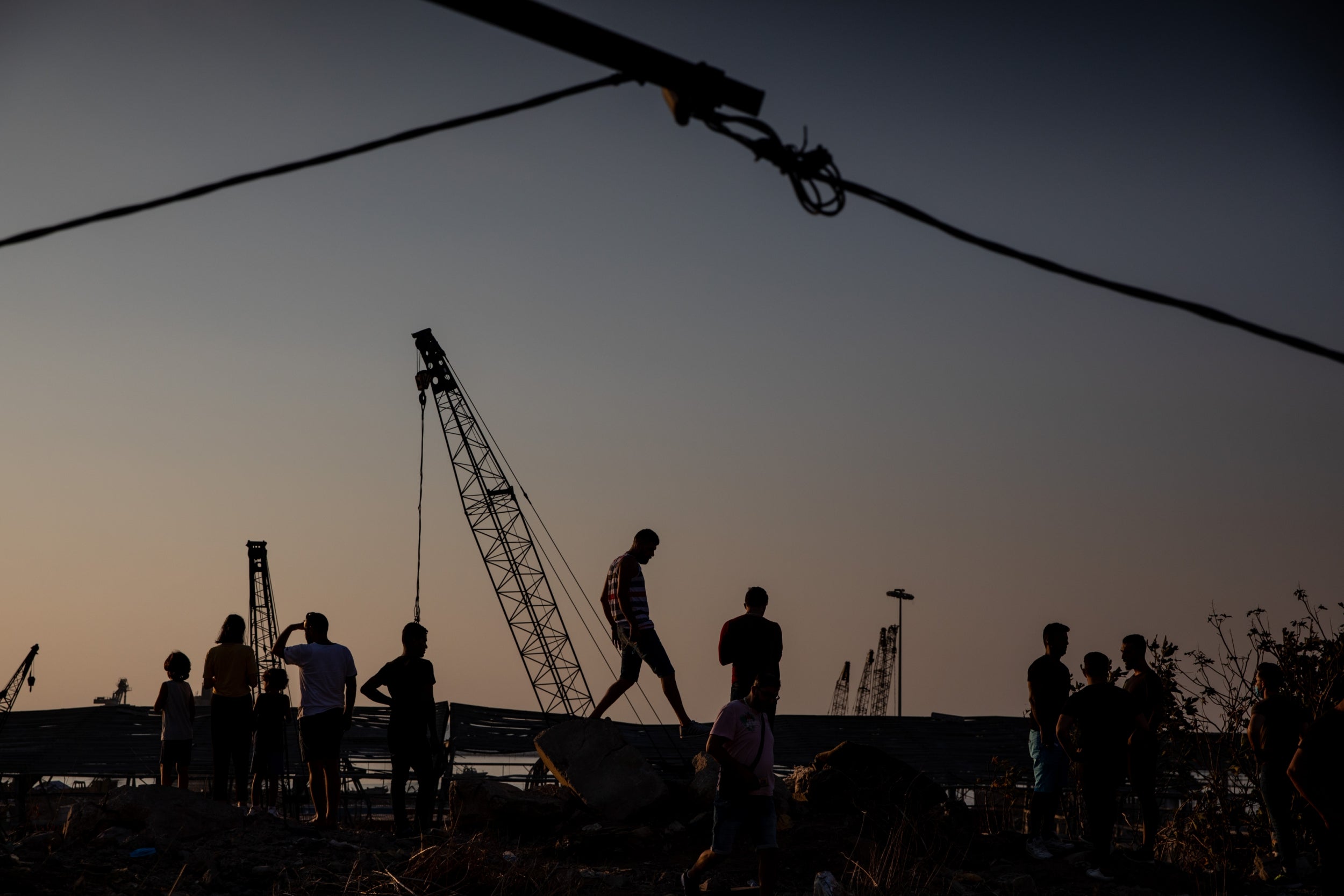 People stop to view the destroyed Beirut port