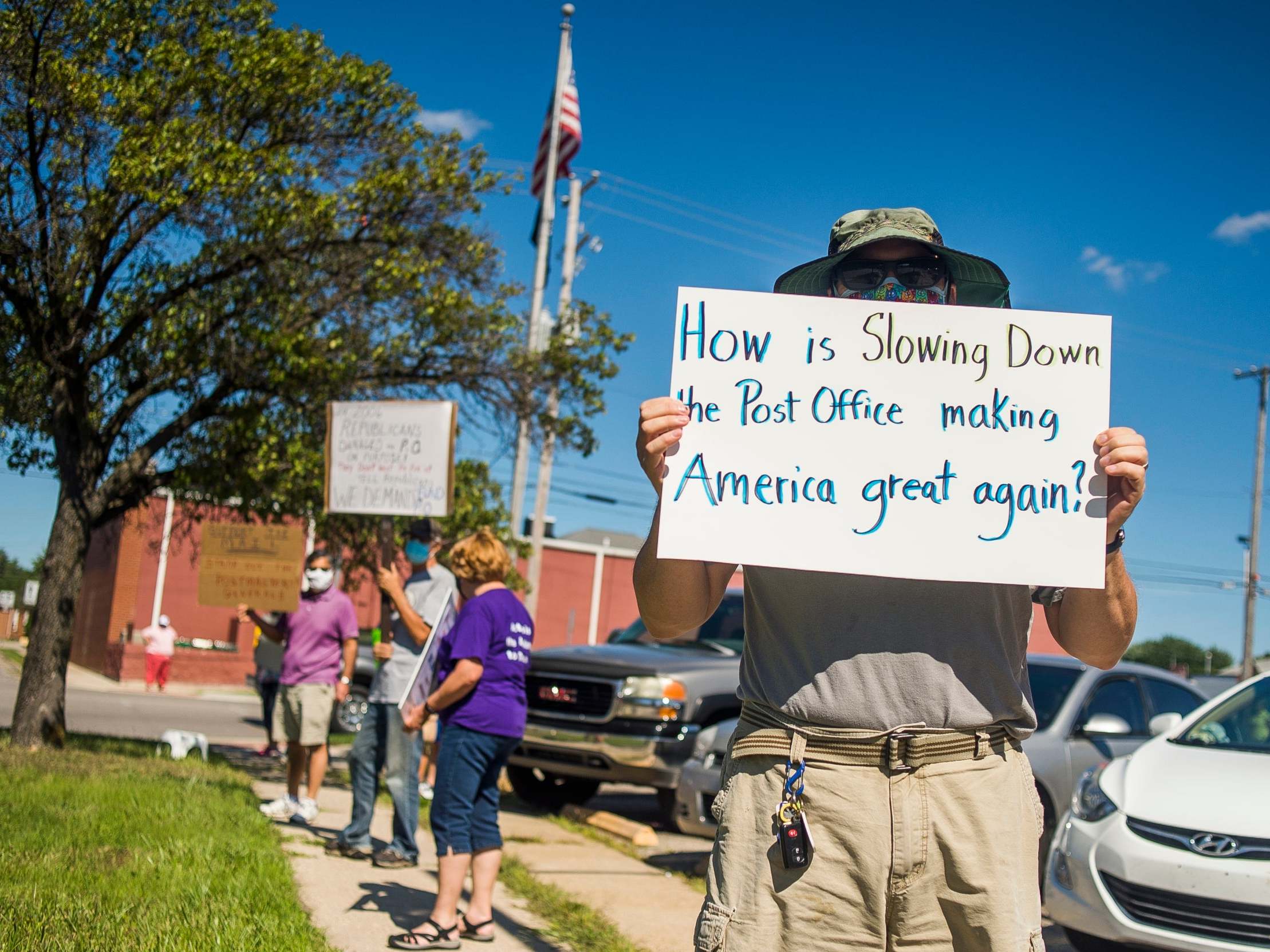 Protesters gather in front of a US Post Office in Midland, Michigan this week to protest recent changes to the USPS under new Postmaster General Louis DeJoy
