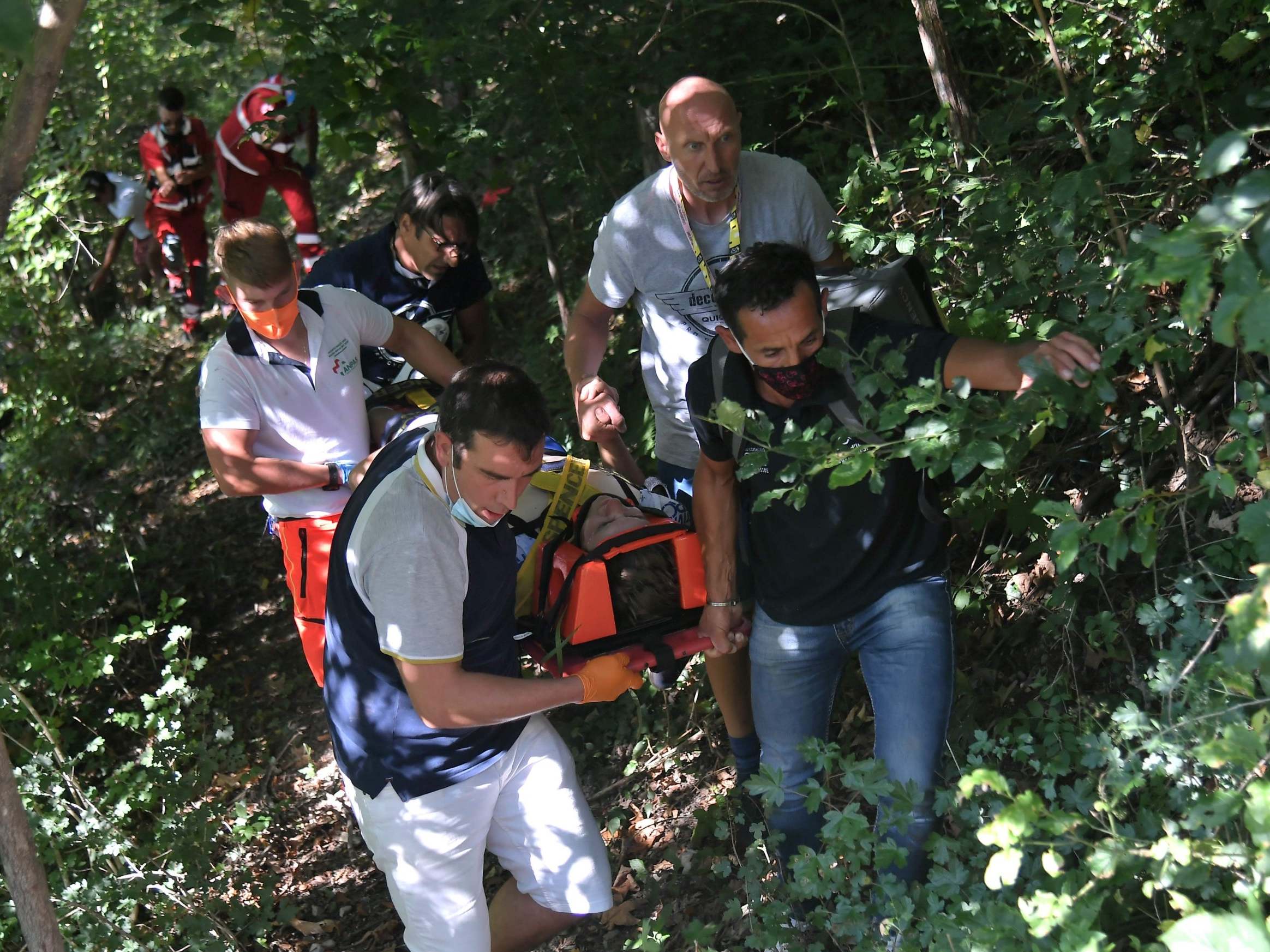 Remco Evenepoel is carried to an ambulance after crashing