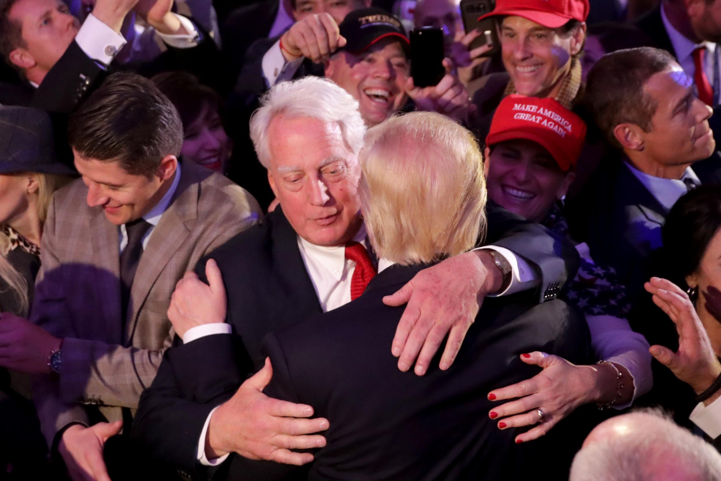 Robert hugs Donald Trump at the president-elect’s victory celebrations in 2016