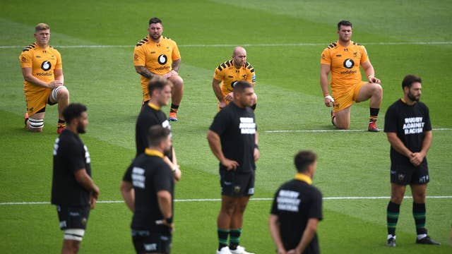 Wasp players take a knee as Northampton Saints stand prior to kick-off in their Premiership match at Franklin's Gardens