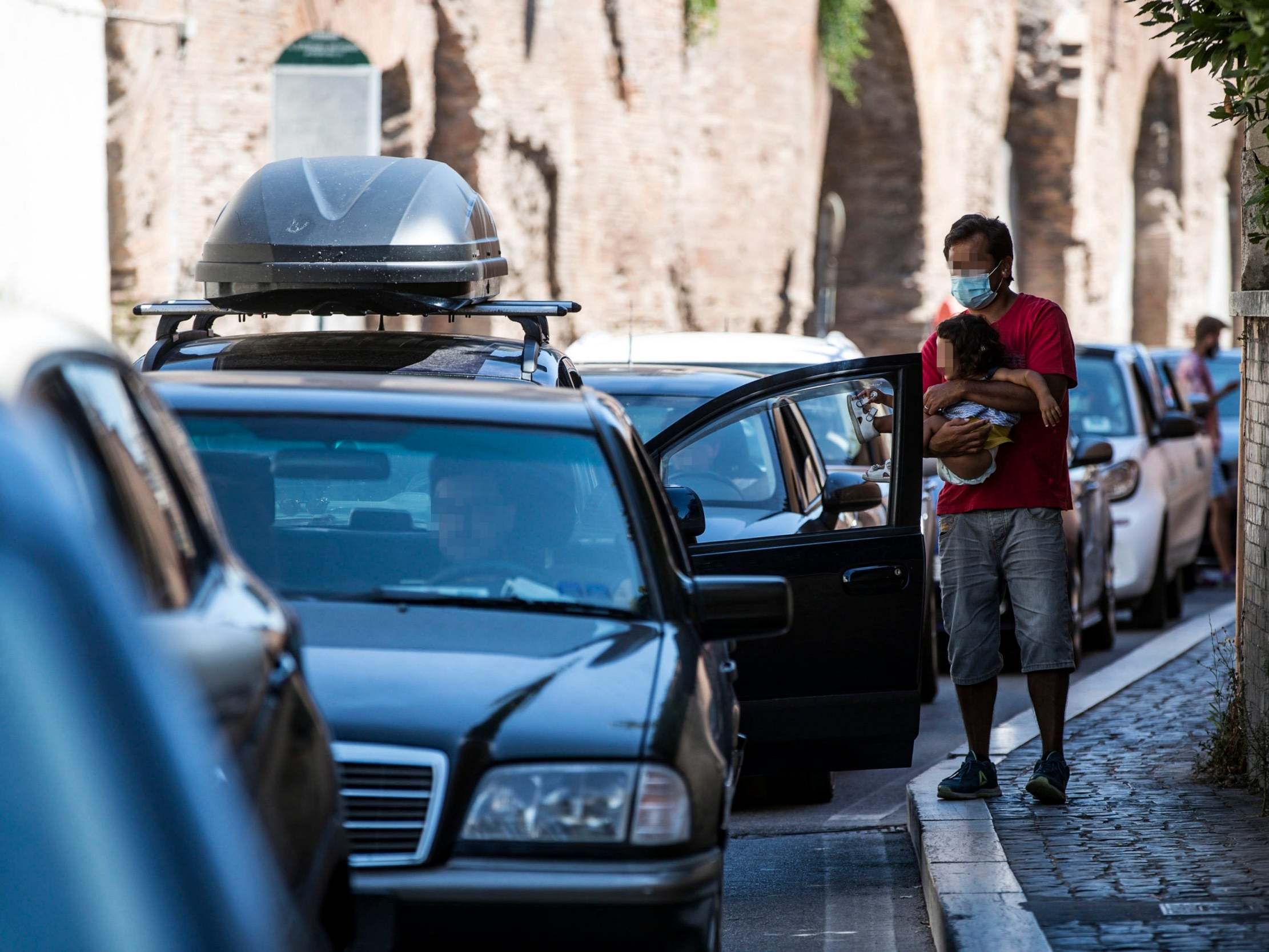 Travellers returning to Rome from high-risk areas wait to be tested on Sunday