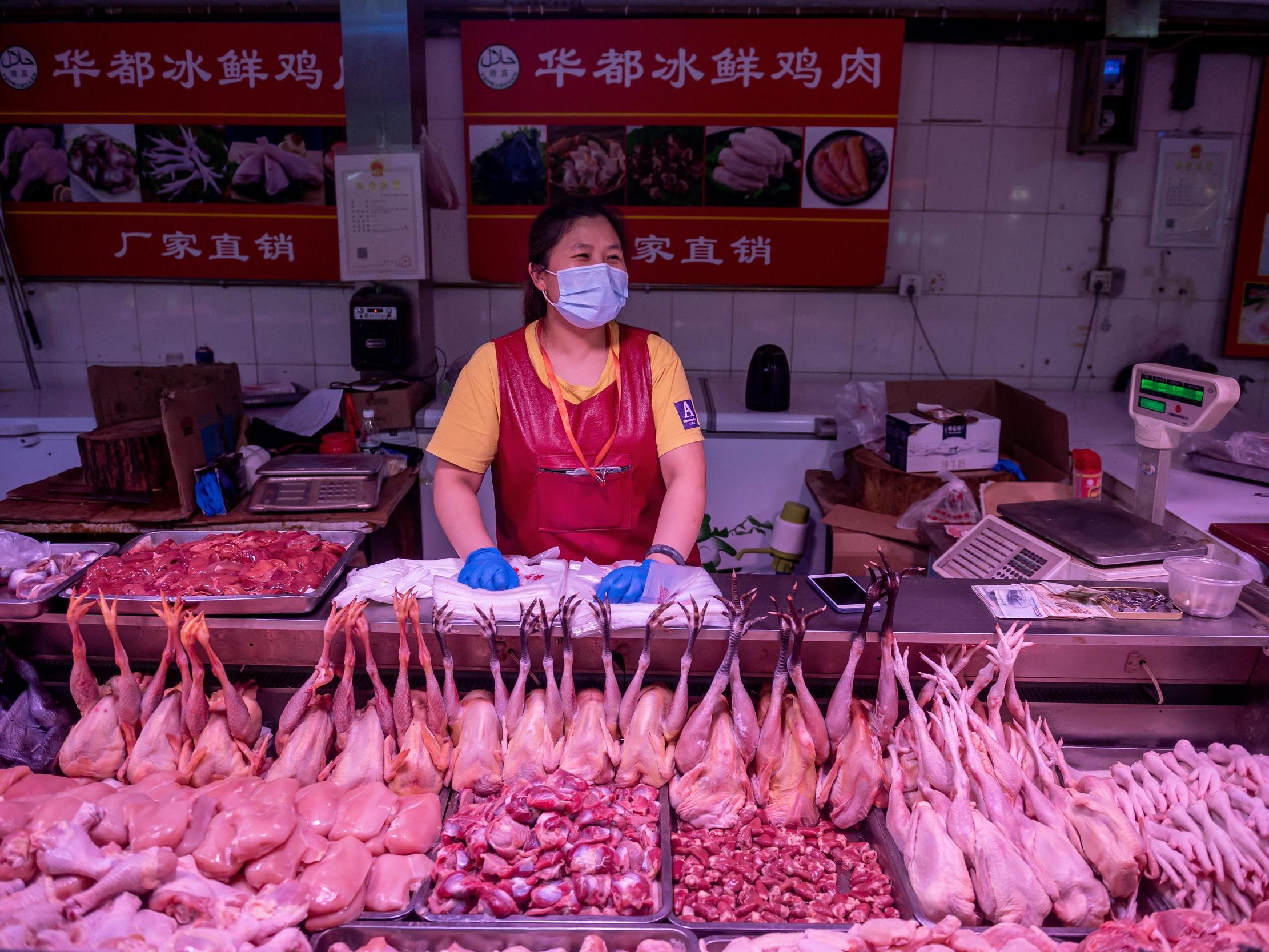 A vendor waits for customers at a chicken stall at a market in Beijing