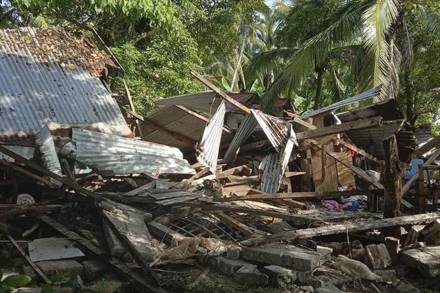 A toppled house is seen in Cataingan after a quake struck Masbate province, central Philippines