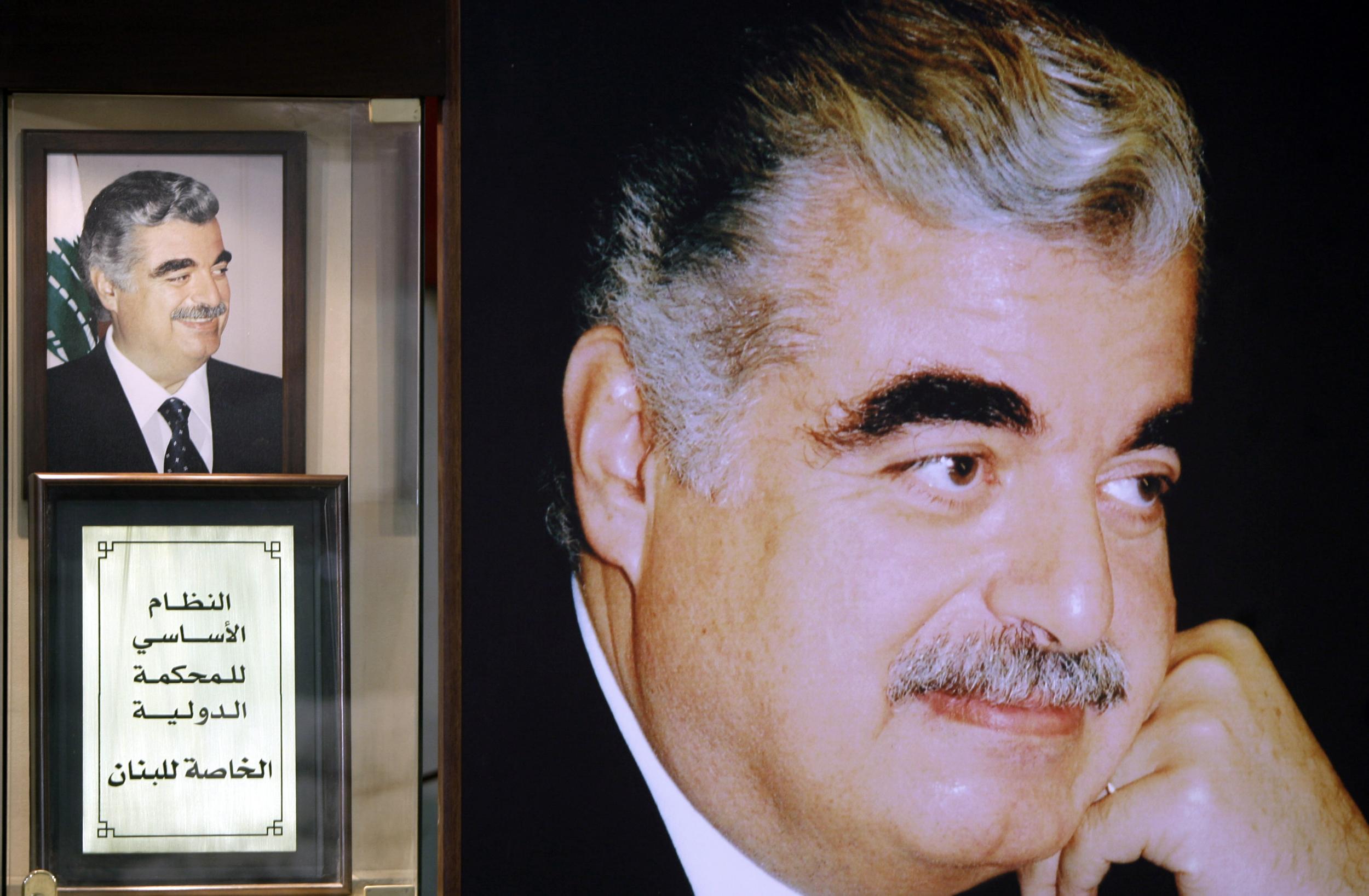 A replica of the text of the Special Tribunal for Lebanon next to pictures of Rafiq Hariri at his shrine in downtown Beirut