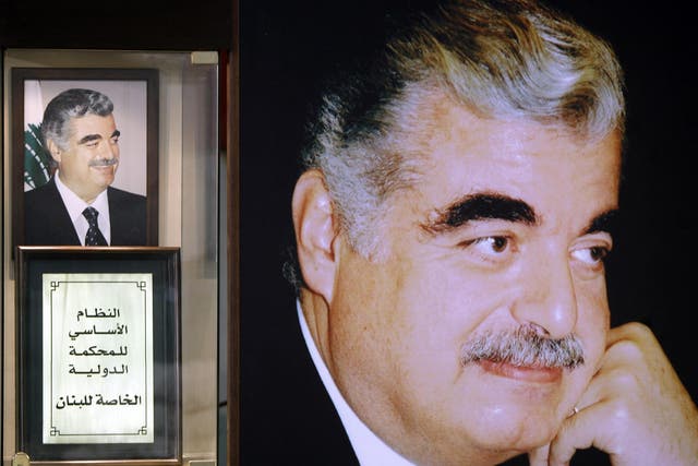 A replica of the text of the Special Tribunal for Lebanon next to pictures of Rafiq Hariri at his shrine in downtown Beirut