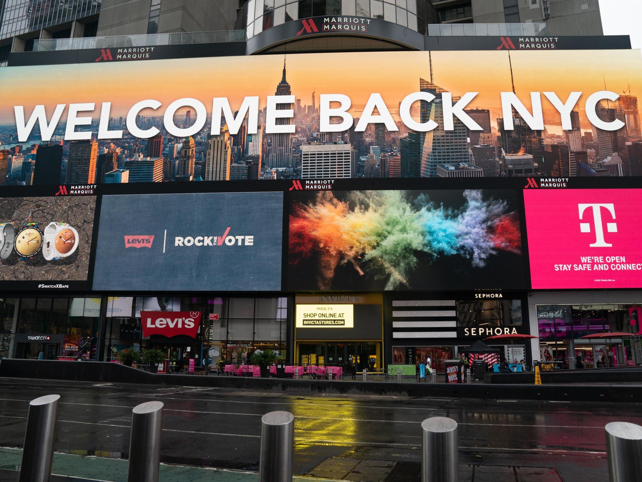 A billboard welcomes people back to New York City in Times Square five months after it shut down to combat the coronavirus