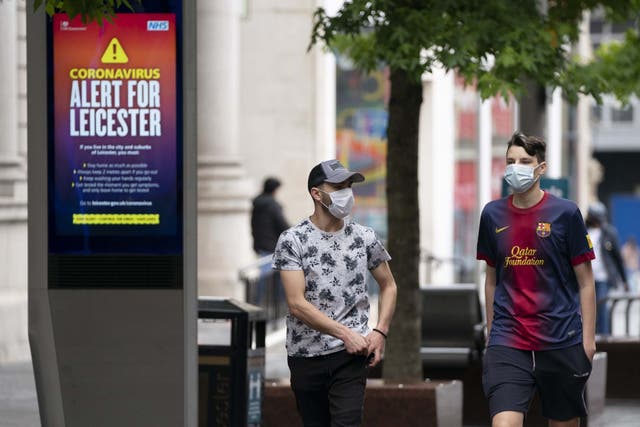 People wear masks on a Leicester street after a localised lockdown