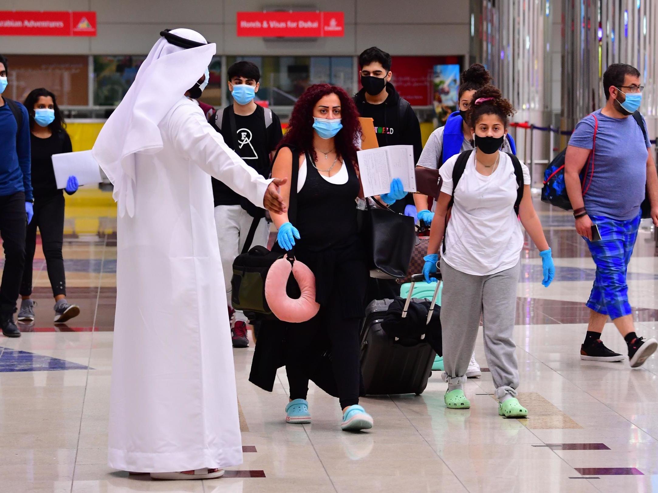 Tourists are seen arriving at Dubai airport on 8 July, the day the country reopened its doors to international visitors
