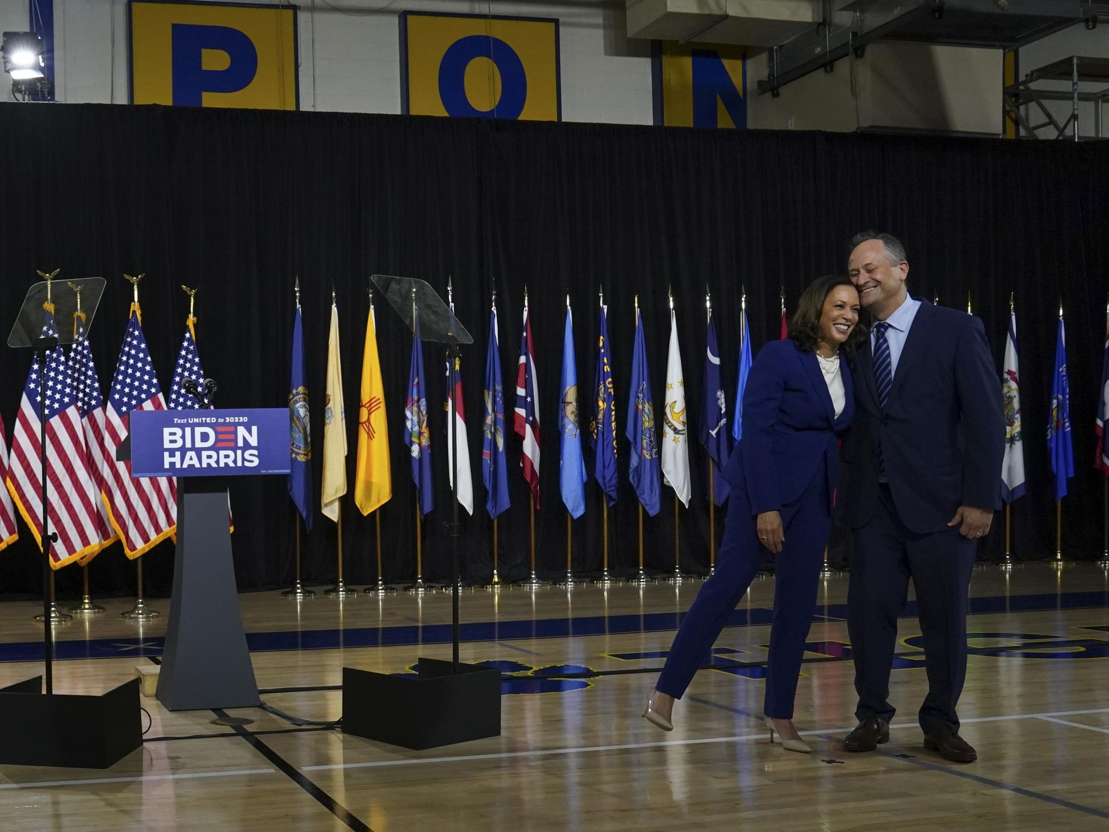 Senator Kamala Harris leans on husband Doug Emhoff after being introduced by Joe Biden as his running mate during an event in Wilmington