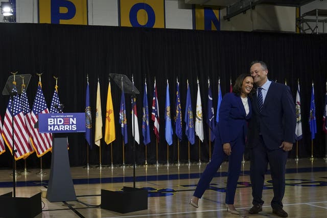 Senator Kamala Harris leans on husband Doug Emhoff after being introduced by Joe Biden as his running mate during an event in Wilmington