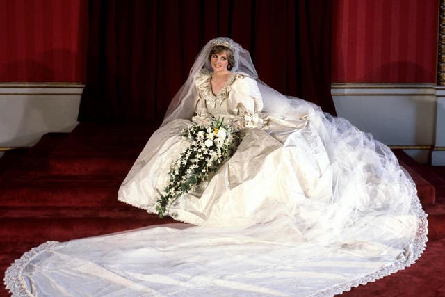 The Princess of Wales seated in her bridal gown at Buckingham Palace after her marriage to Prince Charles at St. Paul's Cathedral