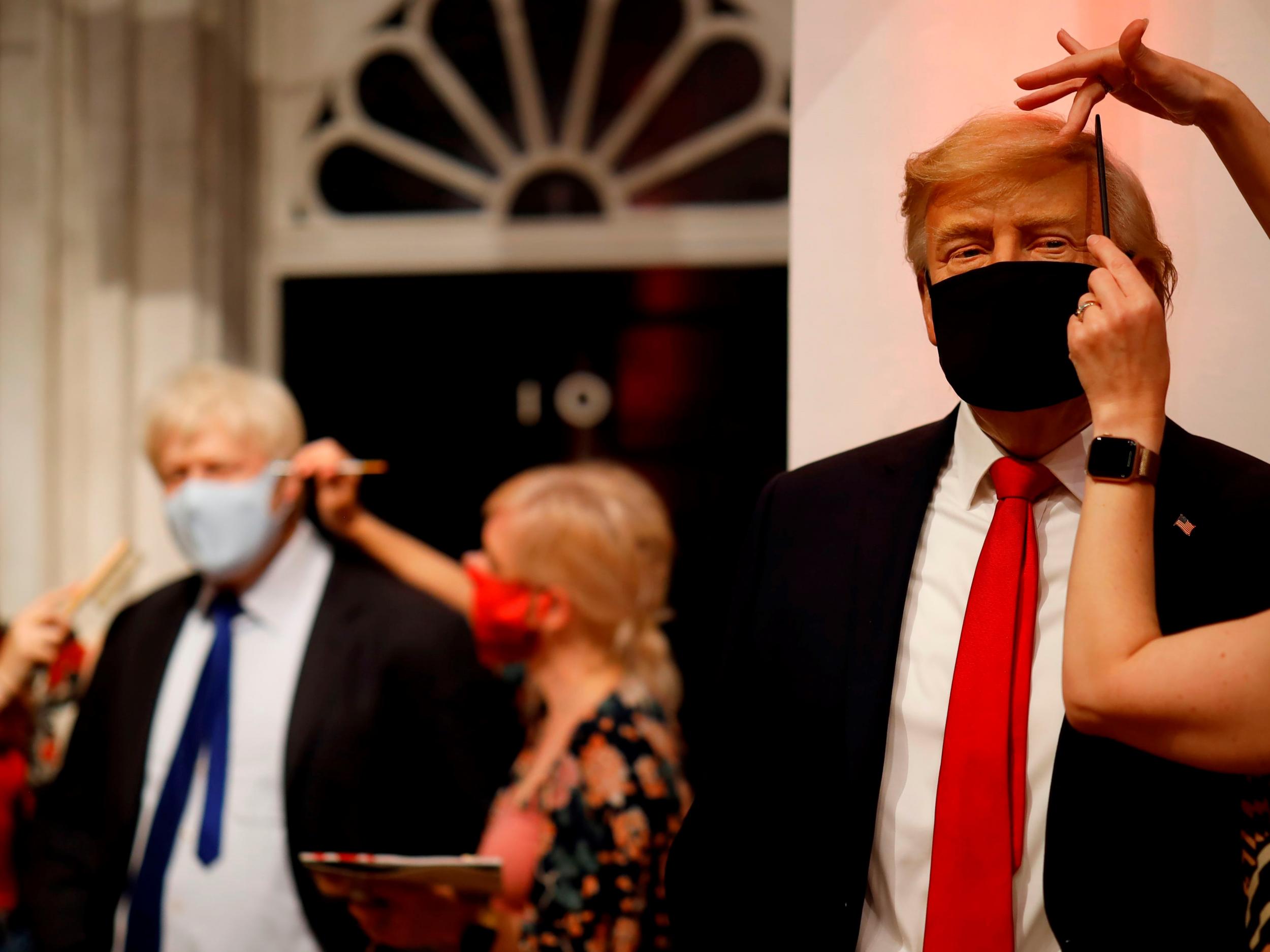 Artists put the finishing touches to wax figures Britain's Prime Minister Boris Johnson and US President Donald Trump at Madame Tussauds on 30 July, 2020. New polls suggest the leaders lack public trust when it comes to handling the pandemic