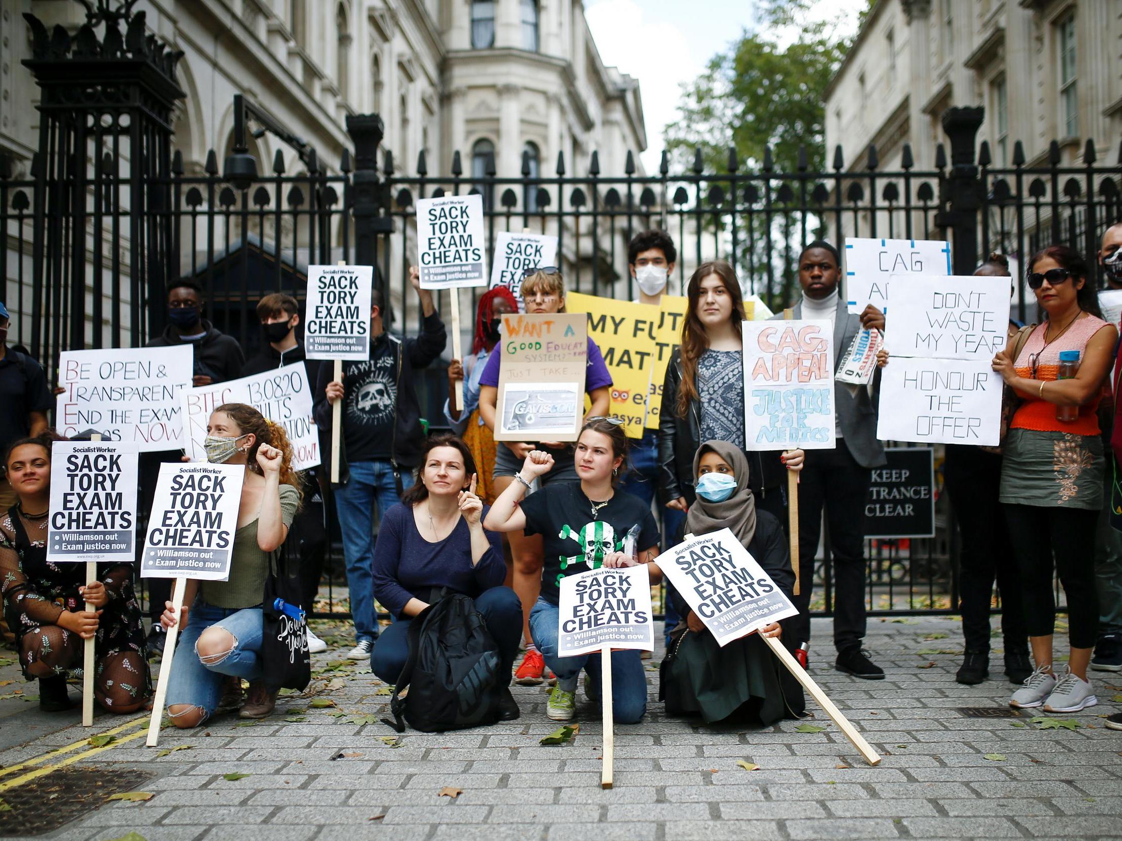 People take part in a protest over the governments handling of exam results outside Downing Street