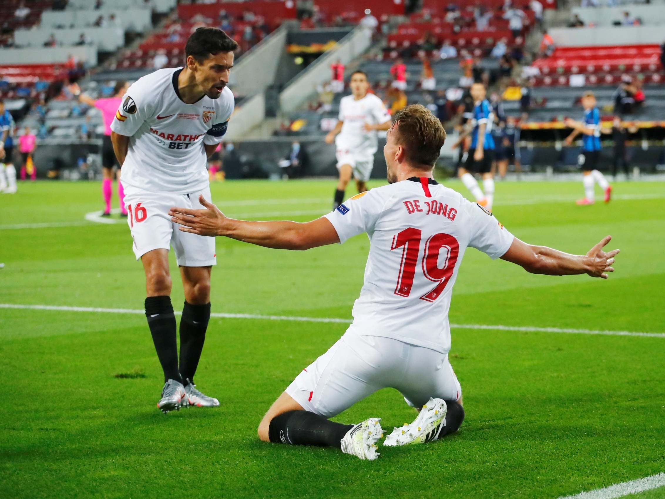 Jesus Navas celebrates with Luuk de Jong, who netted twice in the final