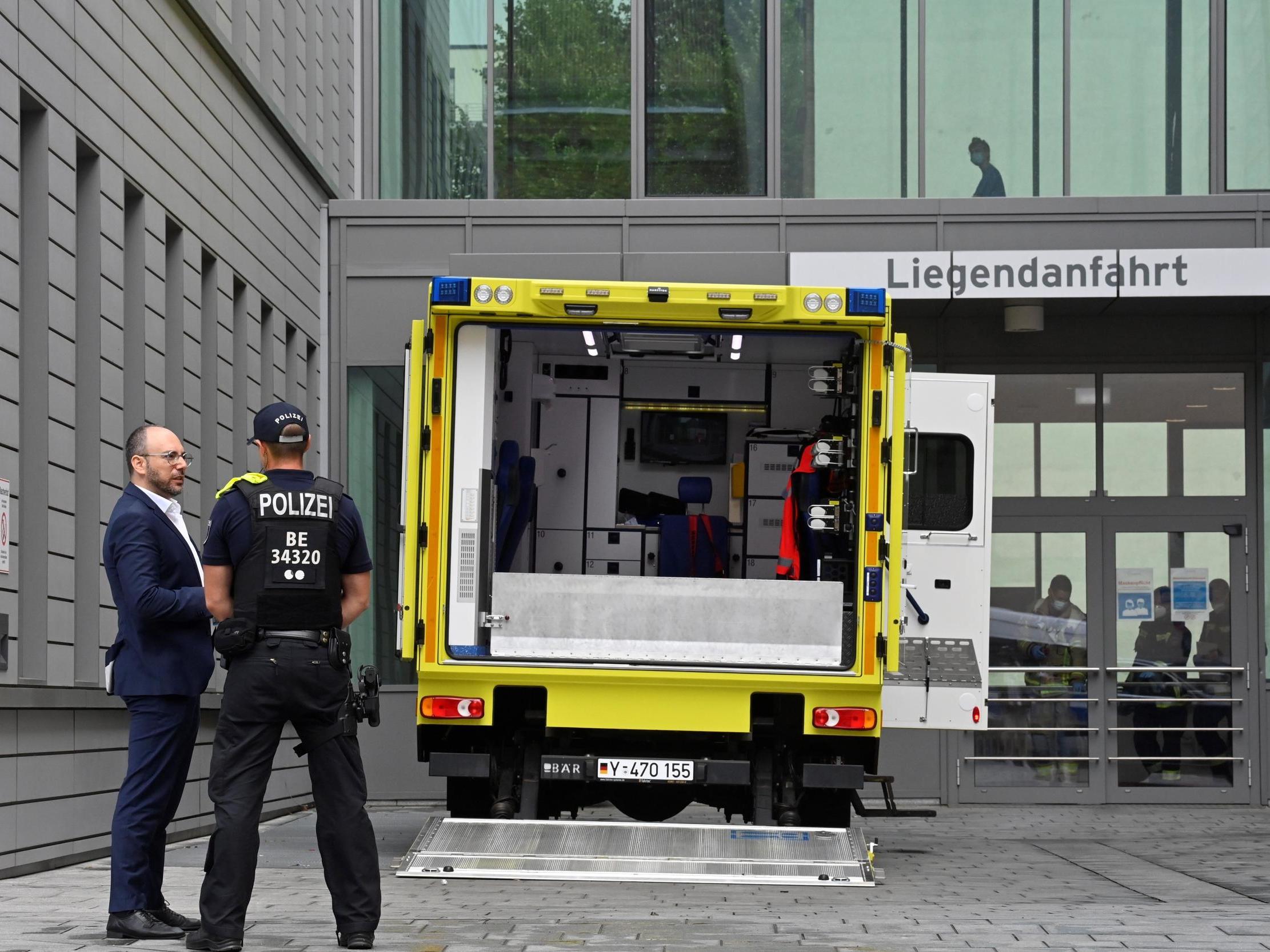 German security stand in front of the army ambulance which transported Russian opposition figure Alexei Navalny to hospital on Saturday